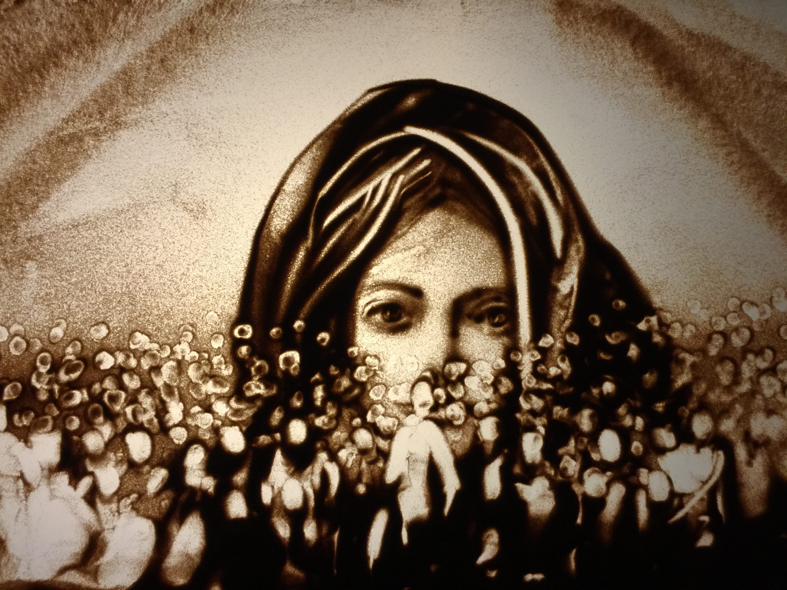 Sandbild von Frau mit Kopftuch